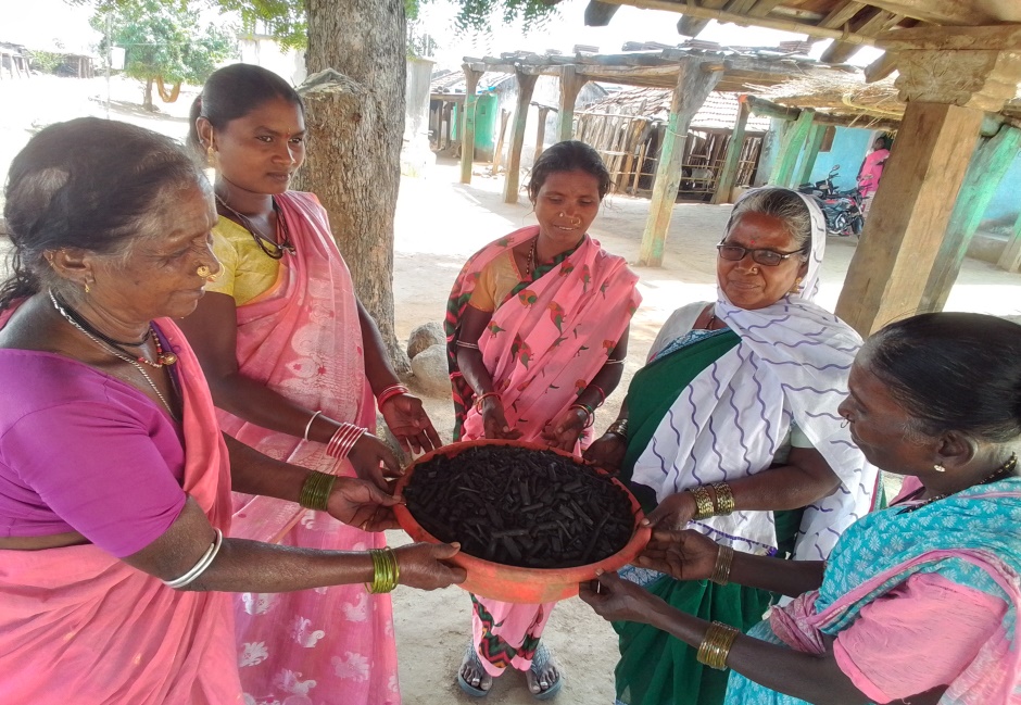 Women farmers holding a basket of compost they made